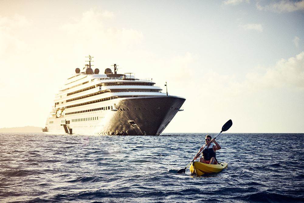 man kayaking next to ritz yacht